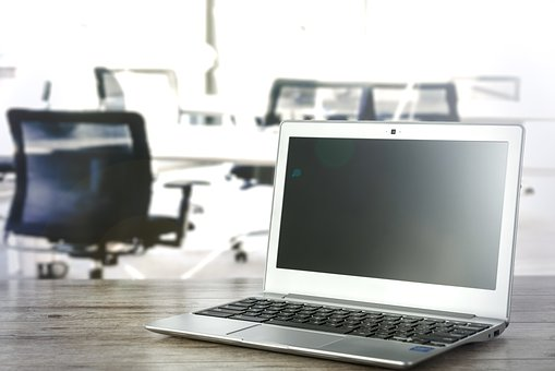 an open laptop on a desk in an office space