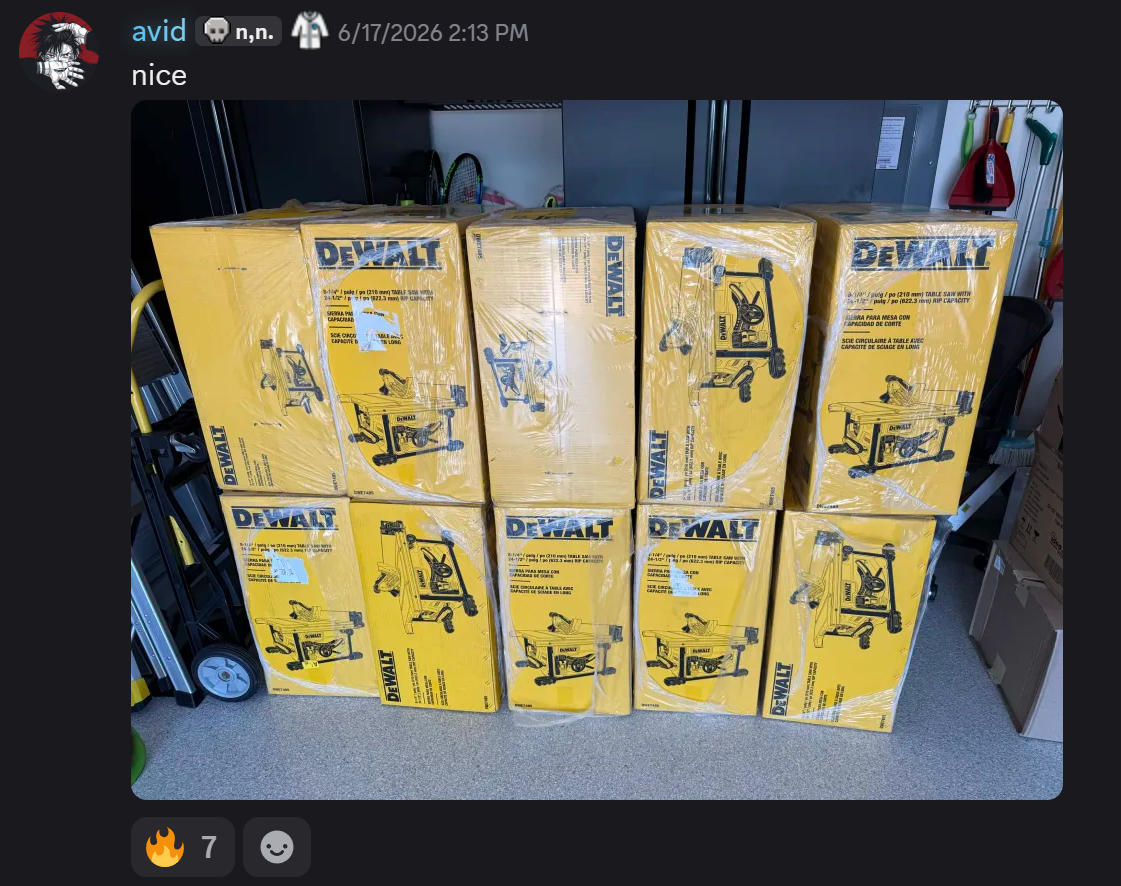 Community delivery screenshot showing a garage stack of boxed DEWALT table saws after the Amazon pricing error shipped.