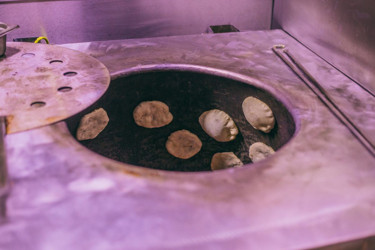 Naan Indian Bread Hand Made and Cooked in a Clay Oven in Old Spiltafields  Market, London 