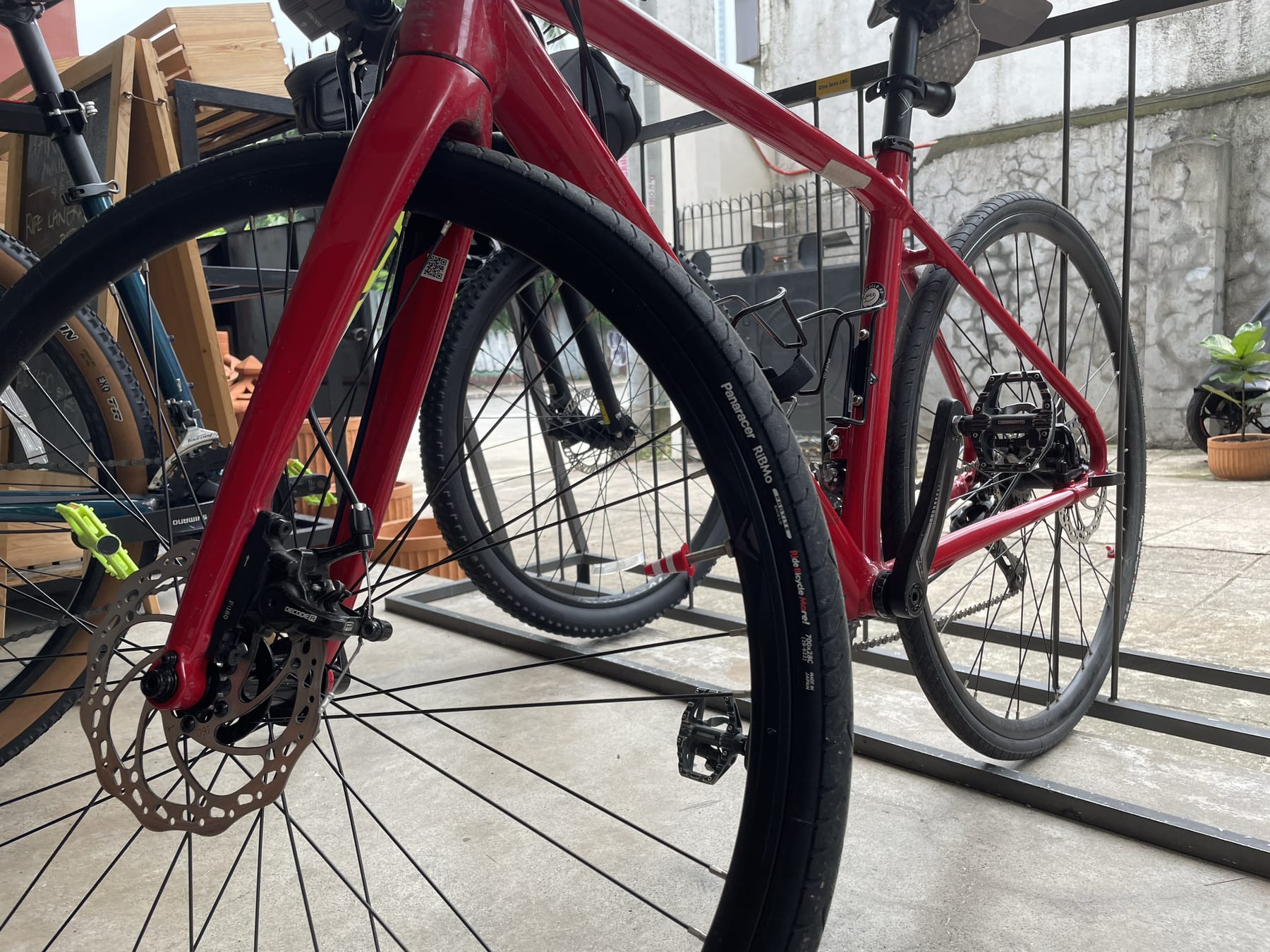 photo of the 3d-printed traffic cone valve cap attached to the front wheel of Chi's road bike