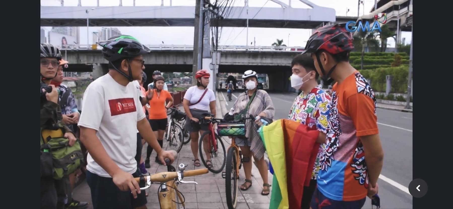 snippet from the I-Witness documentary, entitled Trip to Pasig, where Chi is seen wearing her signature red helmet and white crop top shirt and gray shorts standing right by the side of Pasig River with other bike commuters, prepping for their ride to Manila Boat Club. Seen on the left side wearing a black helmet and white shirt with the red I-Witness logo is Howie Severino, the documentary's narrator and who the camera was focused to.