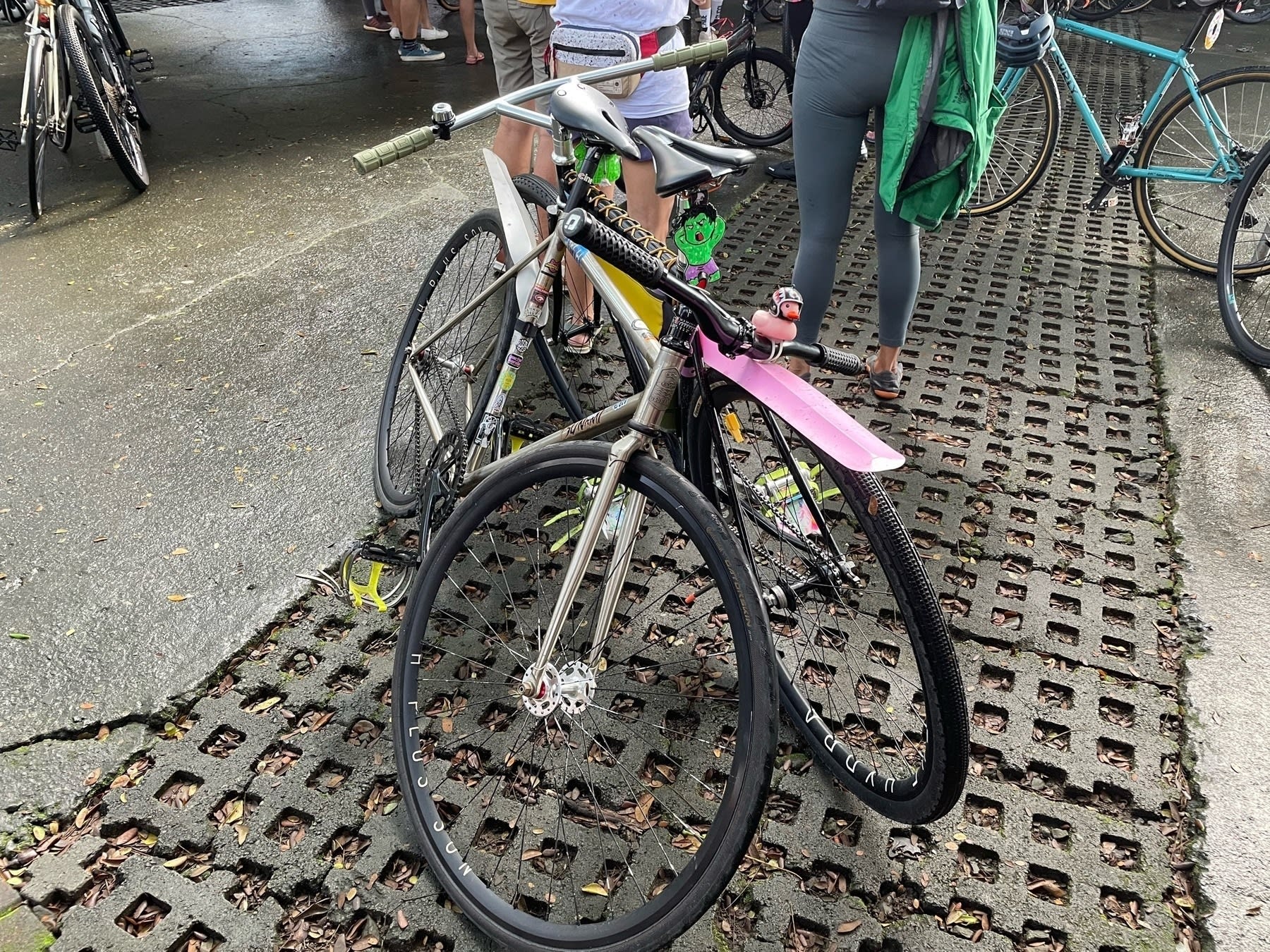 Two full bikes leaning against each other, making them both be balanced and not falling over.