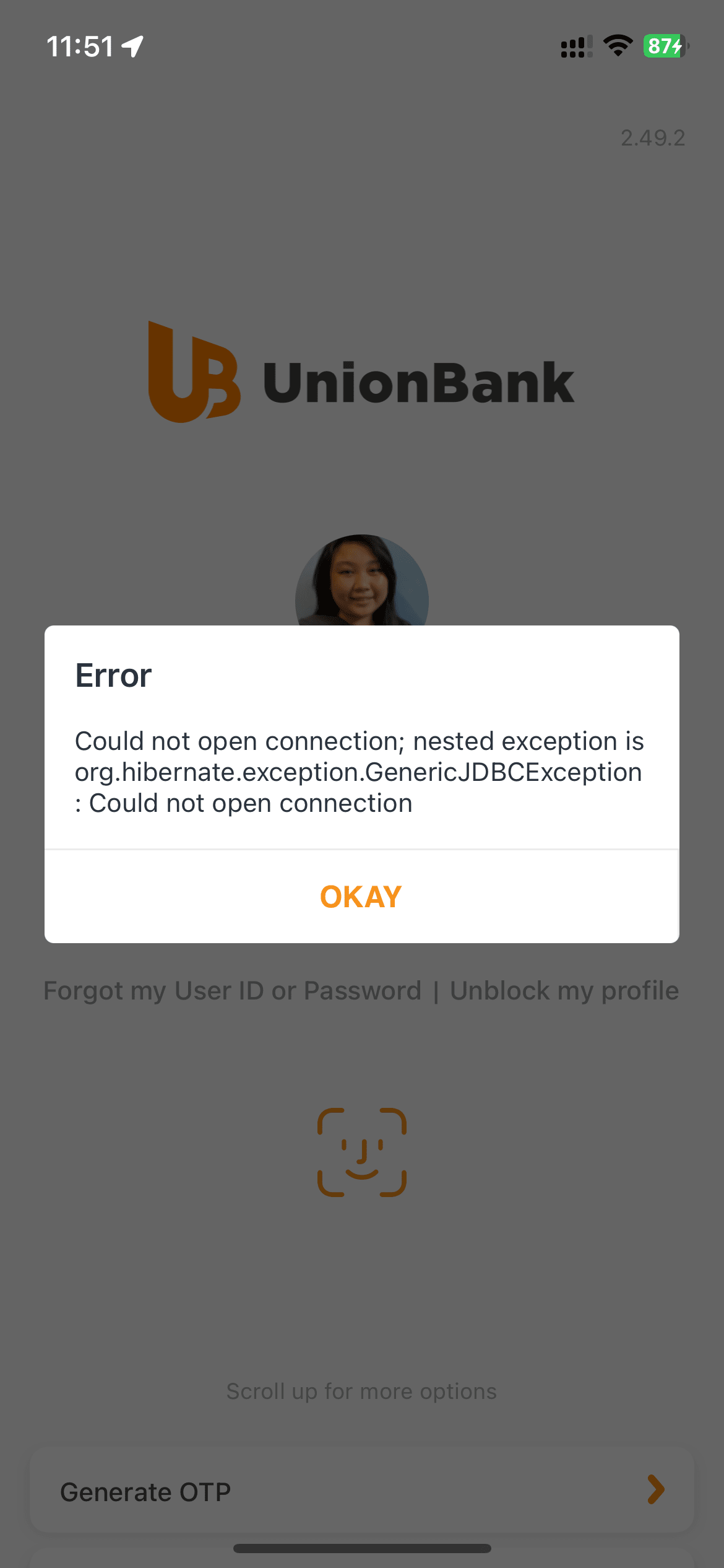 Mirror selfie of Chi wearing a white knitted top, an unbuttoned black polo shirt, dark blue jeans with a belt, and brown slip on loafers.