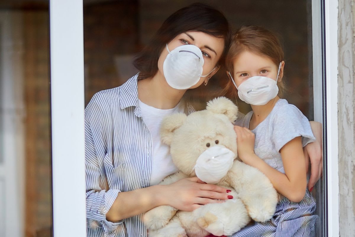 Mother and daughter wearing masks