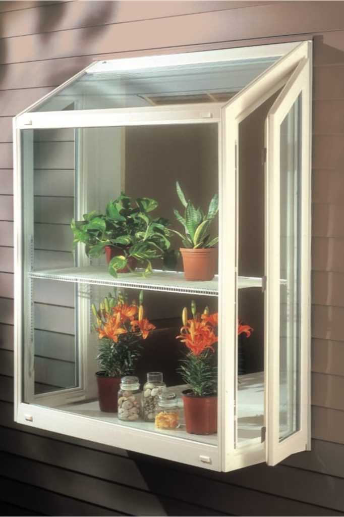 Garden window with shelves and potted plants displayed inside.