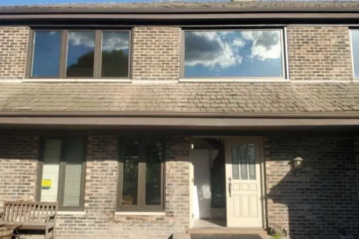 A brick house with windows and a door.