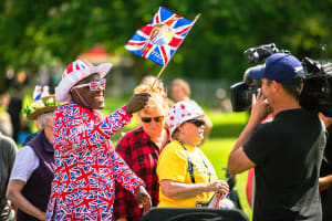 Wedding spectator waving Harry and Meghan Union Jack flag.