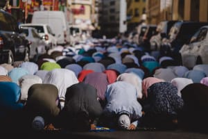 Muslims kneeling and praying