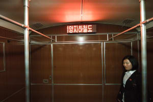 A North Korean standing on the metro in Pyongyang