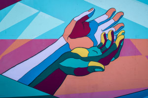 Painted mural of colourful hands