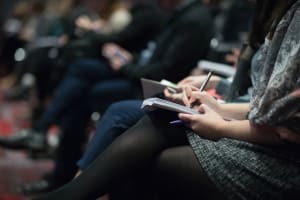 Journalist writing in notebook