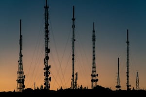 Cellular towers stand tall in the sunset
