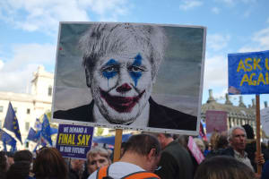 A portrait of UK Prime Minister on a sign, altered to look like that of the character Joker from the 2019 major motion picture Joker.