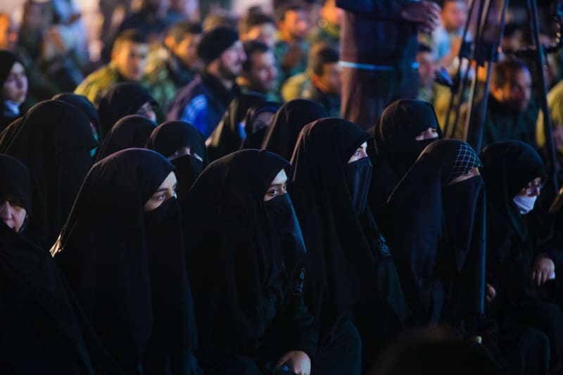 Niqab clad women sitting together