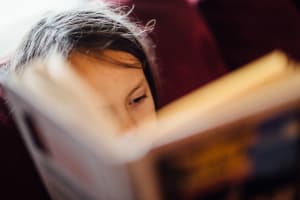 A young girl reading a book