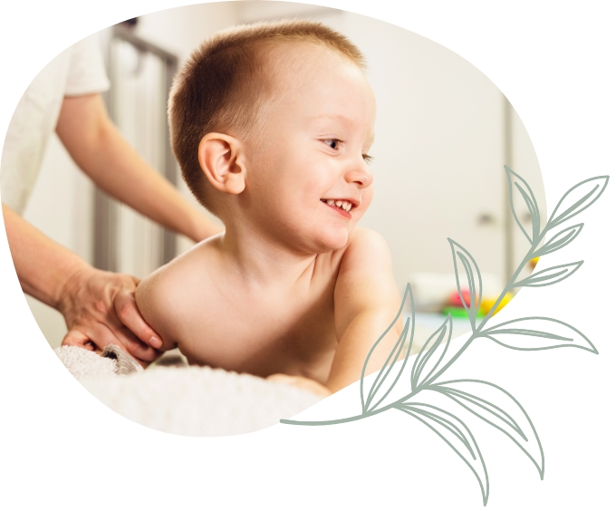 Smiling toddler receiving chiropractic care
