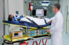 Doctor with patient on patient transport