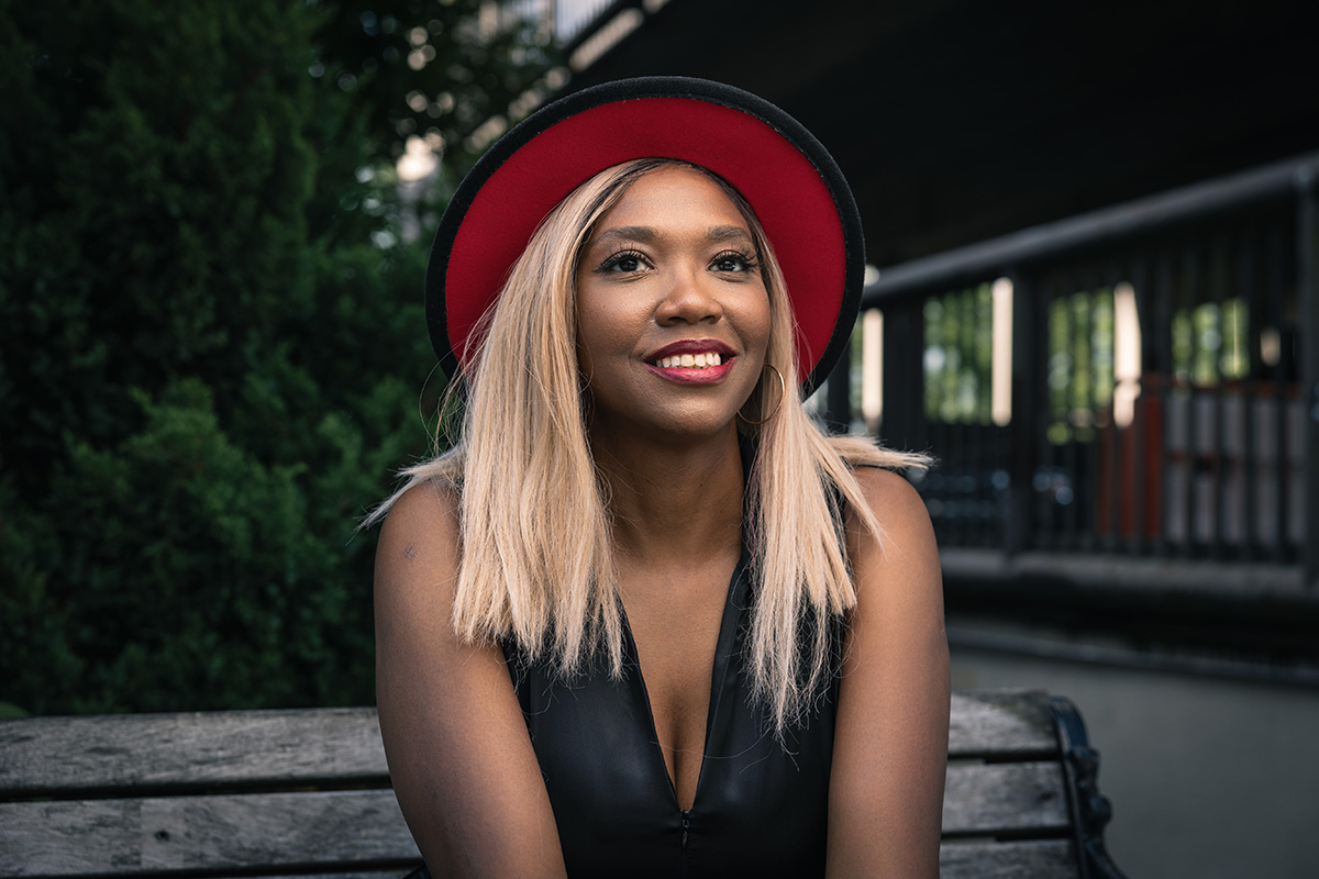 Medium close up of an african american woman with blonde hair wearing a hat in Asheville, NC