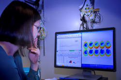 Student in the cognitive neuroscience lab viewing data on a monitor.