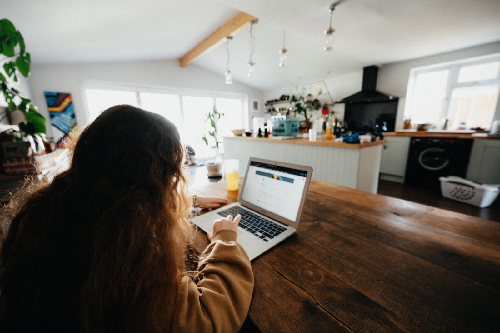 Student in front of a laptop in their kitchen