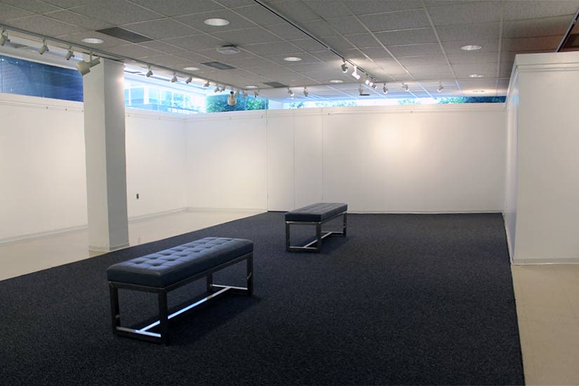 View of the main gallery and two benches in the middle of the room of the Beverly and Sam Ross Gallery