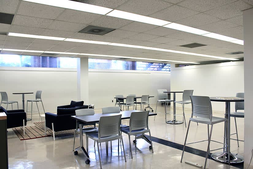 View of the the Beverly and Sam Ross Gallery foyer with various tables and chairs