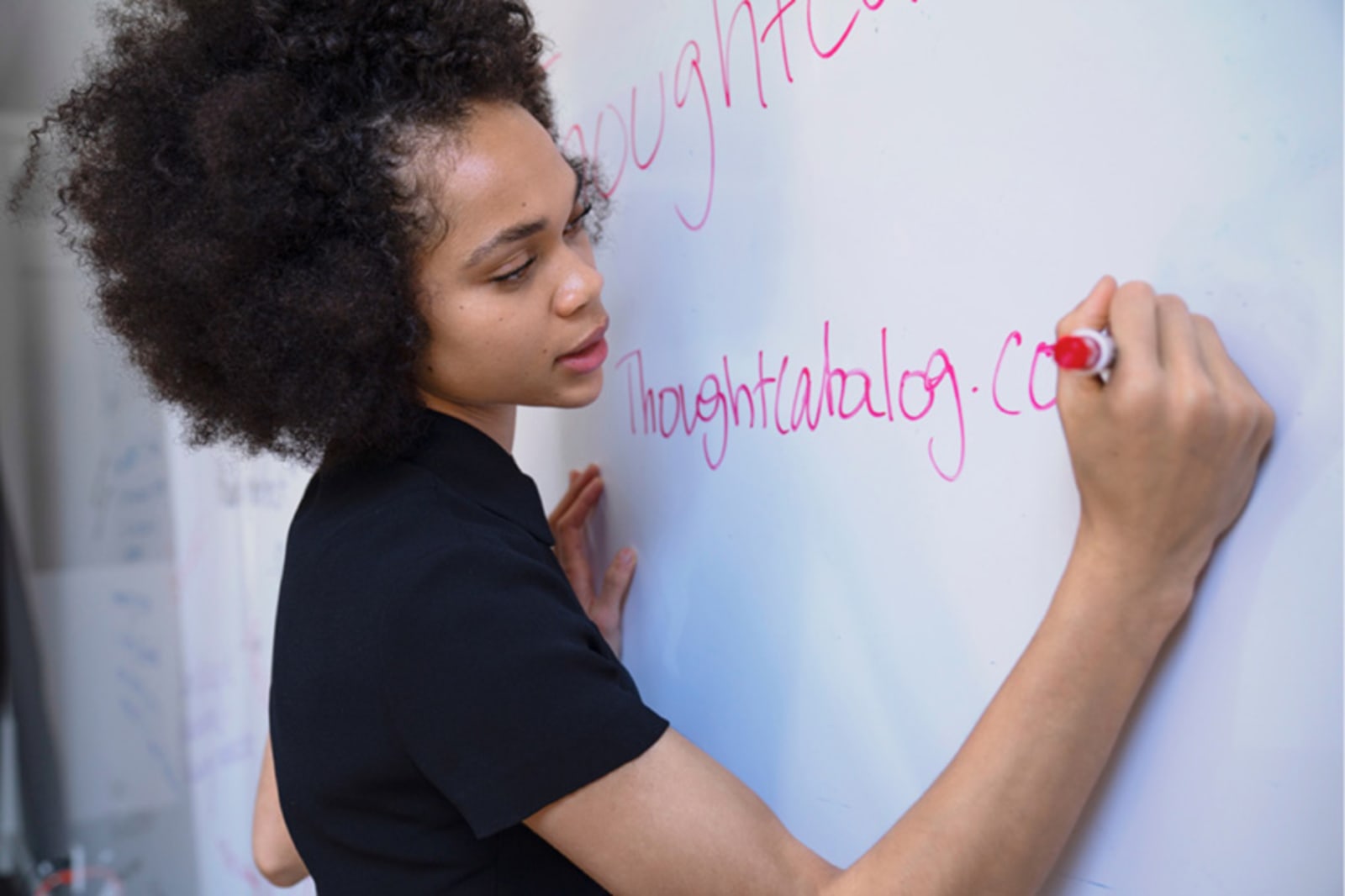Student writing on whiteboard