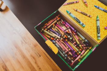 a pencil box full of various Craylola crayons Liberal Studies