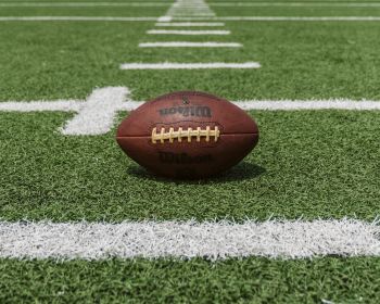 Sport Management: football sitting on astroturf