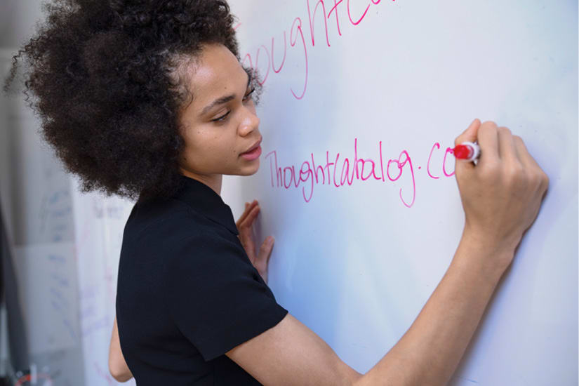Student writing on whiteboard