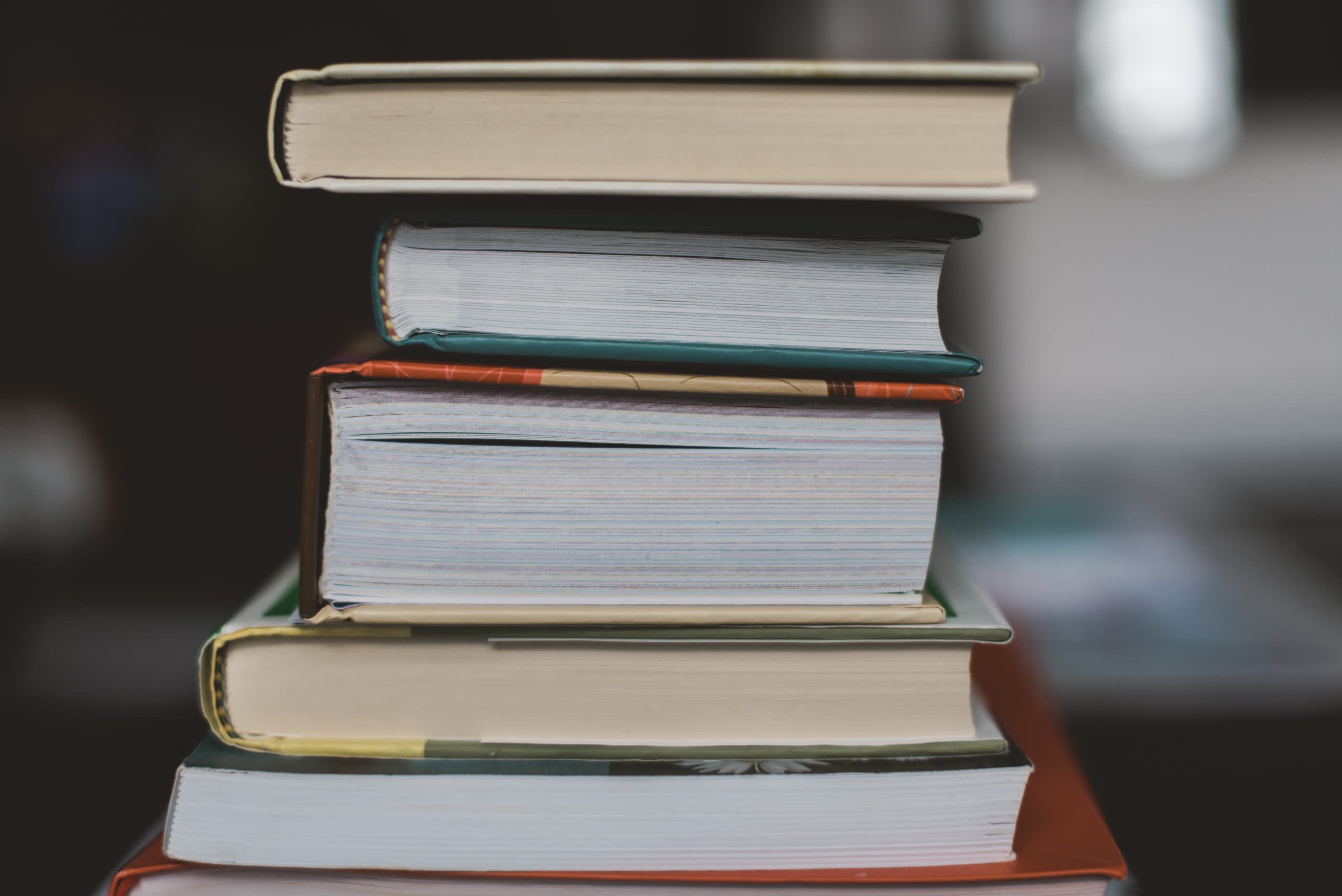 Books of various thickness stacked on top of each other English