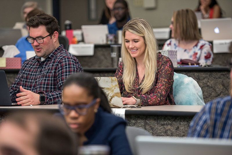 Man and Woman in auditorium graduate classroom