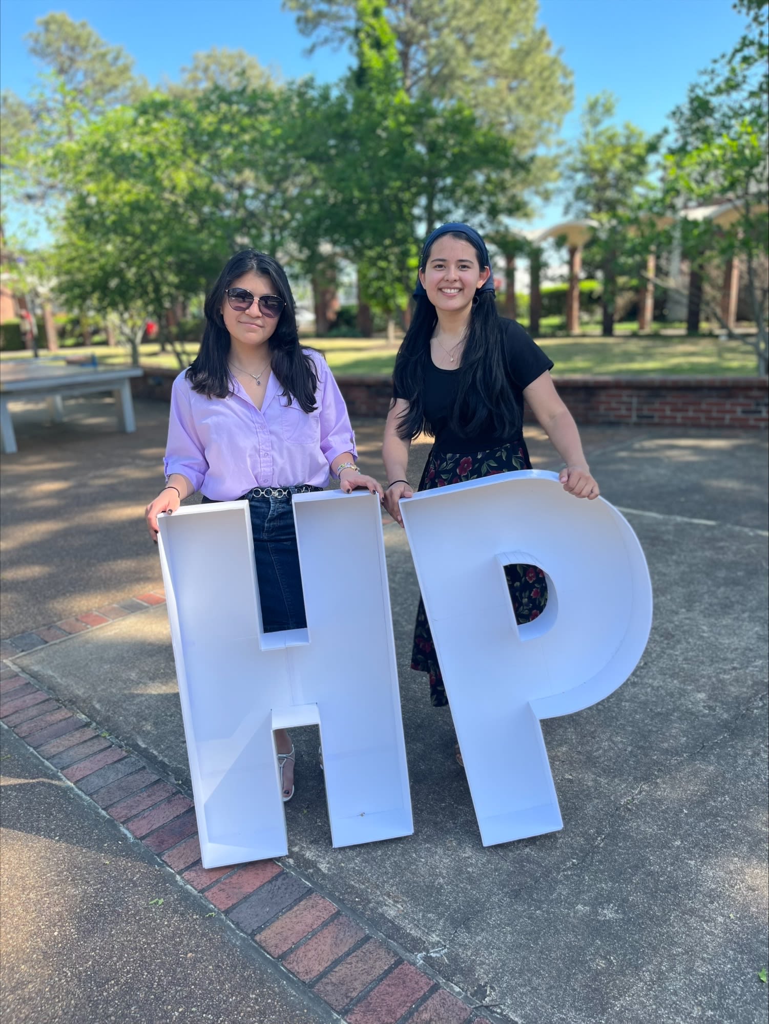 Honors students holding the big letter H & P for Honors Program.