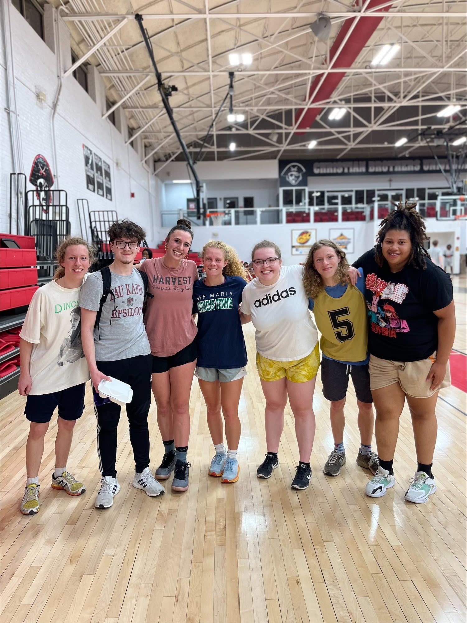 A group of honors students smiling as a group in the Gym on CBU campus,