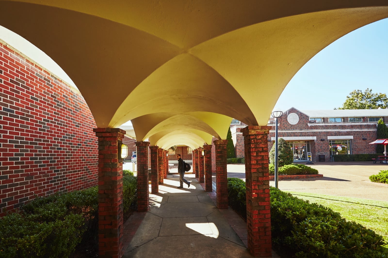 CBU student on campus under the arches