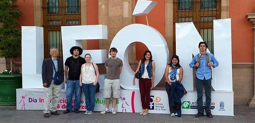 Students standing in front of a large