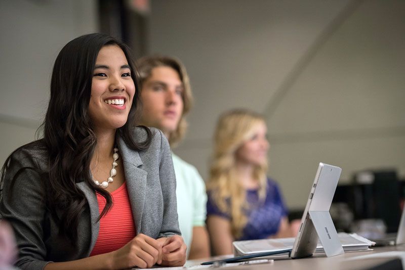 Woman in graduate class with computer