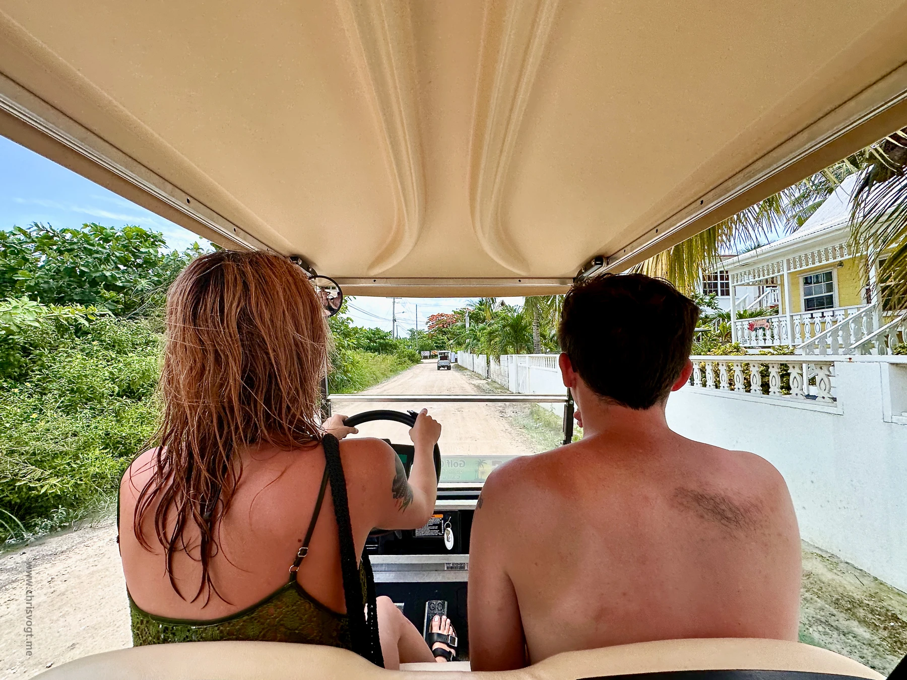 Nick riding in the passenger seat while his cousin drives us to Secret Beach in a golf cart