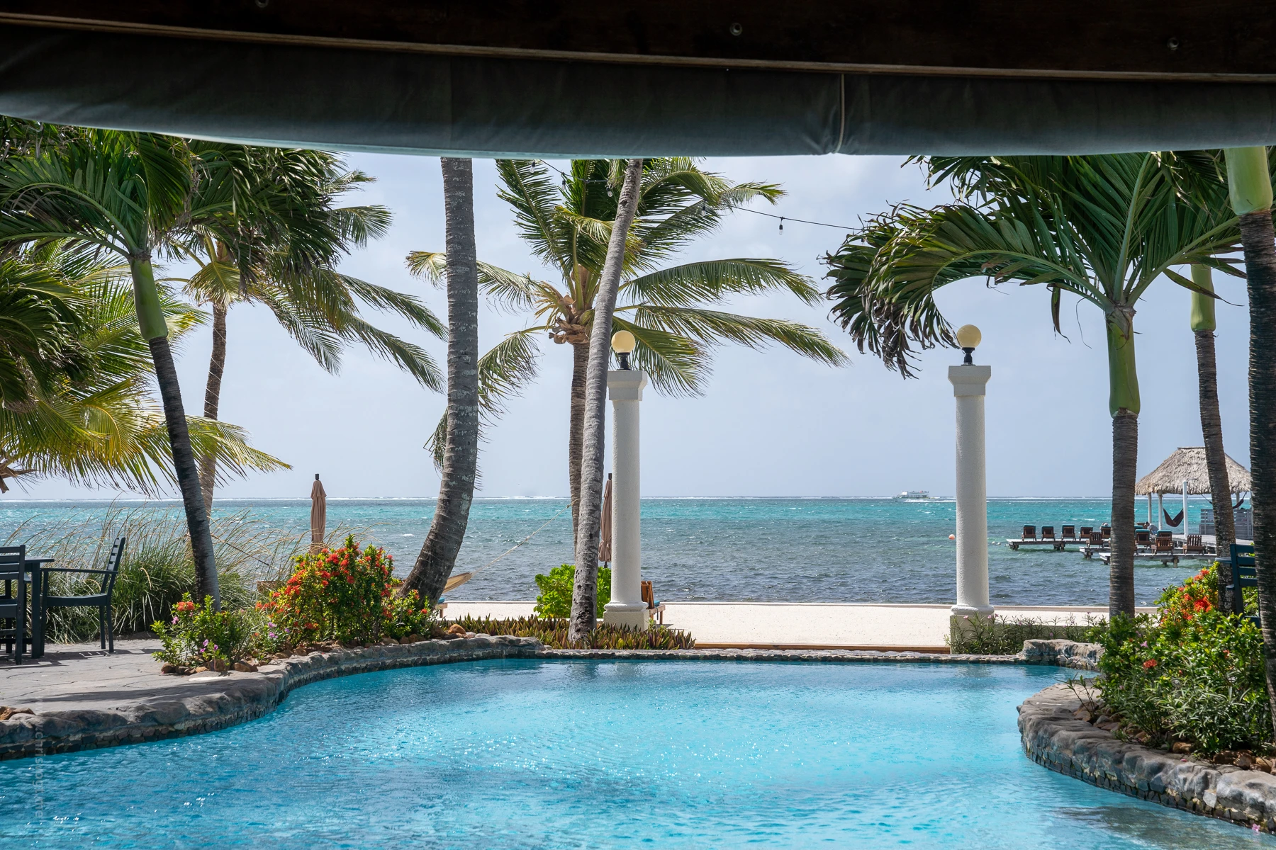 The swimming pool and pier at Pelican Reef Villas