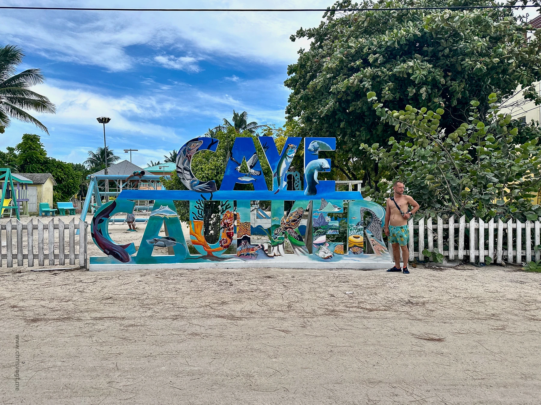 Me standing next to the Caye Caulker sign in Belize.