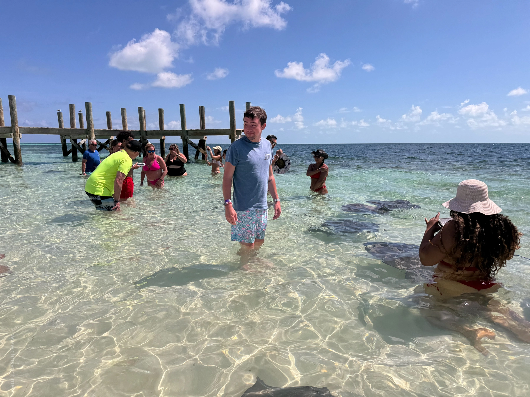 Nick standing in the water with stingrays in Bimini, Bahamas.