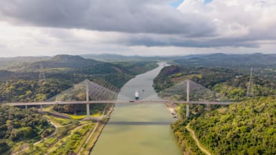 Aerial view of Panama Canal bridge over tropical rainforest..png