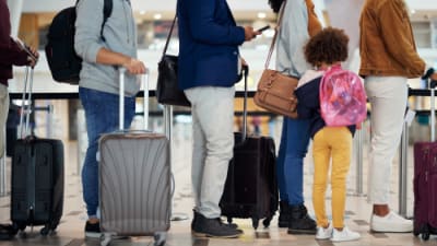A queue of people waiting in an airport.png