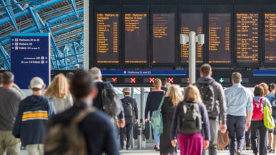 A Crowd Of Commuters Walking Toward Their Platforms At A UK Train Station