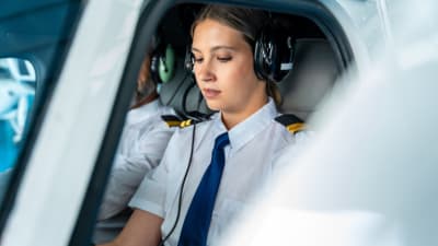 Young pilot trainee sitting in an aircraft cockpit.png