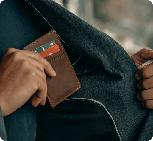 a man putting his wallet in the inside pocket of his jacket