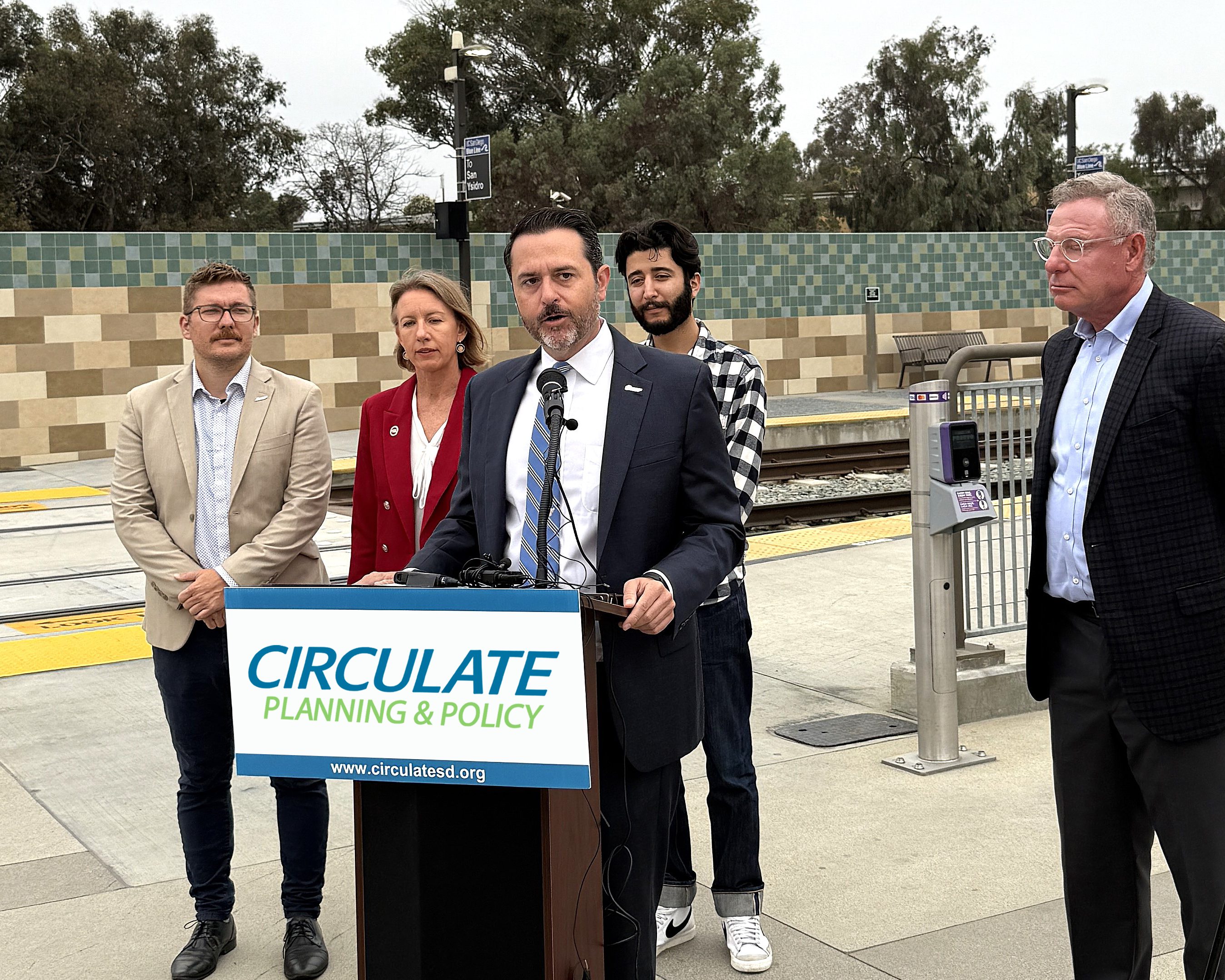 Colin Parent speaking at podium