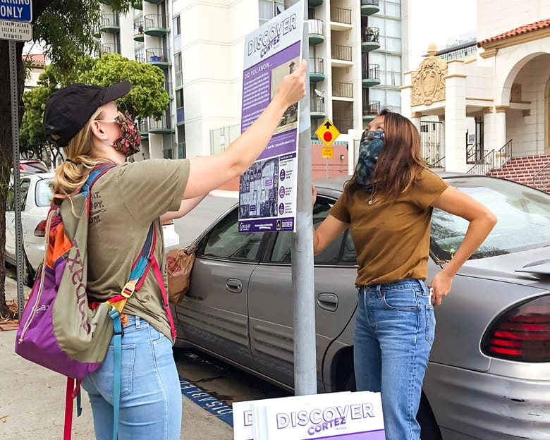 Circulate staff hanging a sign