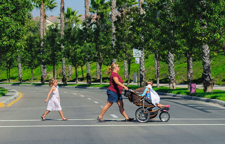 Family crossing the street at a crosswalk