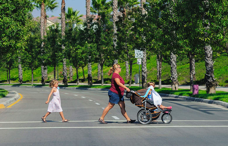 Family crossing the street at a crosswalk Family crossing the street at a crosswalk